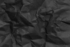 black crumpled paper is shown in close up