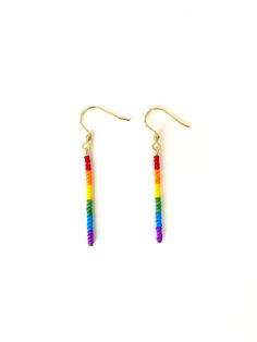 These minimalist drop earrings are made with thick gold plated wire and glass seed beads. A simple, every day look, these earrings have a rainbow design. These hang approximately 2 inches long and are .5 cm wide. These earrings come on either gold plated wires or Sterling silver ear wires. For gold plated wires, if you would like to switch out the wires for 14k gold filled, niobium ear wires (hypoallergenic), or gold plated lever backs- please add the following listing to your cart: https://www. Cheap Rainbow Jewelry For Pride, Lgbtq Beaded Jewelry, Rainbow Bead Earrings, Rainbow Dangle Earrings For Everyday, Rainbow Dangle Jewelry With Tiny Beads, Rainbow Dangle Earrings With Tiny Beads, Rainbow Seed Bead Earrings, Adjustable Rainbow Earrings With Tiny Beads, Rainbow Dangle Jewelry For Everyday