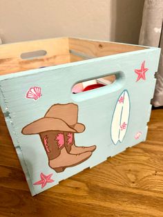 a wooden box with an image of a cowboy boot and starfish on the side