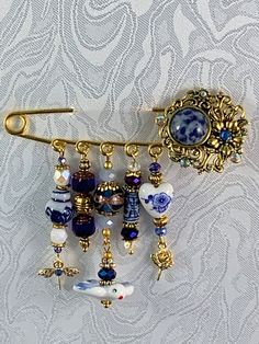 an antique brooch with blue and white glass beadwork on it's side