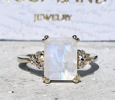 Don't miss this opportunity to own this beautiful gemstone ring crafted in 14k gold filled => Gemstone Type - Moonstone, Clear Quartz => Gemstone Cut - Faceted => Gemstone Size - 8*10 mm, 2 mm => Total Number of Gemstones - 7 => Metal Type - 14k Gold Filled (Tarnish Resistant And Nickel Free) - also available in 925 sterling silver * Please contact me for pricing on a sizes larger than 11 * ~ Feel free to ask me about custom made designs. ❏ Replacements and custom orders : ✪ 925 s White Rectangular Rings With Center Stone, Rectangular Moonstone Ring For Anniversary, White Rings With Rectangular Stone For Promise, White Rectangular Stone Promise Ring, Wedding Crystal Ring With Rectangular Gemstone, White Radiant Cut Gemstone Jewelry, Rectangular Moonstone Ring Gift, White Rings With Rectangular Stone For Gift, White Rectangular Gemstone Rings