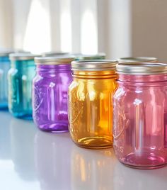 colorful mason jars lined up in a row