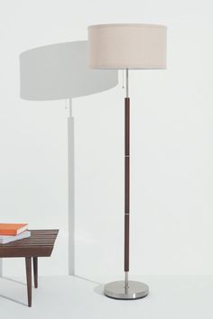 a floor lamp with a table next to it