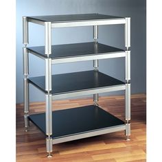 three tiered shelving unit with black top and silver legs on wood flooring