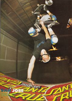 a man on a skateboard doing a trick in the air with his hands up