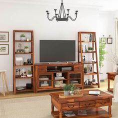 a living room filled with furniture and a flat screen tv on top of a wooden stand