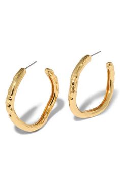 These modern hoop earrings feature a molten, sculptural silhouette that catch the light from every angle. 1 1/2" drop; 1/4" width Post back 14k-gold plate or sterling silver plate Imported Modern Gold Hammered Hoop Earrings, Contemporary Gold Hoop Earring, Gold Small Hoop Contemporary Earrings, Contemporary Small Hoop Gold Earrings, Modern Hammered Drop Hoop Earrings, Modern Textured Small Hoop Earrings, Modern Textured Gold Hoop Earrings, Modern Hoop Earrings, Tube Hoop Earrings