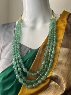 Real Emerald Mint Green Beads Necklace /Haram 3 Lines Each Side /Inches 18 Long /South Indian Jewelry This is a beautiful Long Haram and features Mint Green Beads 3 lines Haram Easily paired with any outfit  any occasion or Gift.  DETAILS: Includes One Real Beads Long Haram  Necklace: 18.0 inches. Adjustable length.Rope closure. Weighs 3.70oz ( gr 106) Material:  Mint Green Beads  Finish: Mint Green Beads Emerald Beads. NOTE: I try my best to show you photos of my products as they appear in real life, but please note that variations in color occur due to differences in lighting and screen settings.  PRODUCT CARE: - Avoid contact with heat/fire, water, and chemicals such as perfumes or any sprays to prevent product damage.  - Store wrapped in butter paper, cotton cloth, or the provided box. Emerald Beads Jewelry Indian, Green Beads Necklace, Beads Haram, Butter Paper, Multi Layer Necklace Beads, Mint Necklace, Long Haram, Green Beaded Necklace, Fire Water