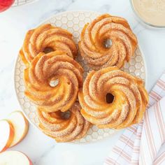 apple cider doughnuts on a plate next to an apple