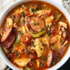 a white bowl filled with meat and vegetable soup