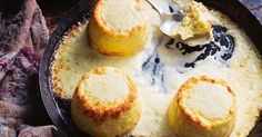 three biscuits and cream in a skillet with a spoon