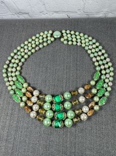 Vintage Beautiful Four Strand Faux Sea Green Pearl, Textured Art Glass, AB Beaded Necklace  17",  c. 1940s Beautiful 1940s necklace in great vintage condition.  Various mix of faux baroque sea green pearls, hand painted white faux pearls with gold detail, AB faceted, faux abalone, and a texted green and clear molded glass beads, etc.   Gorgeous statement piece.  Elegant and classic.   Gorgeous colors for year-round.  Would look great alone or layered with additional jewelry.  Don't miss your cha Vintage Beaded Necklaces With Colorful Beads, Vintage Beads For Jewelry Making, Vintage Adjustable Beaded Necklace With Polished Beads, Adjustable Vintage Beads For Jewelry Making, Vintage Adjustable Necklaces With Colorful Beads, Vintage Multi-strand Beaded Necklace With Colorful Beads, Vintage Green Beads For Jewelry Making, Vintage Multi-strand Colorful Beaded Necklaces, Vintage Multi-strand Beaded Necklaces With Colorful Beads