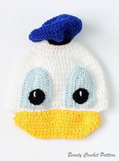 a crocheted ducky hat with blue eyes