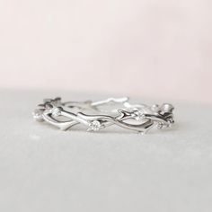 a close up of a silver ring on a white surface