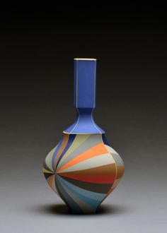 a colorful vase sitting on top of a table