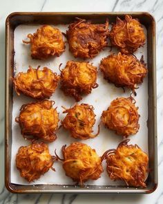 there are many fried food items in the tray on the table, ready to be eaten