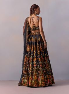 Presenting a contemporary twist on the classic lehenga design, this set features vintage floral and paisley motifs that add a unique charm. Paired with a stylish blouse showcasing a V-shaped neckline and heavy hand embroidery detailing, it beautifully blends tradition with modern flair. Adorn yourself in this vibrant floral ensemble that captures the essence of modern sophistication. Classic Lehenga, Lehenga Design, Paisley Motifs, Black Lehenga, Embroidery Detailing, Stylish Blouse, Lehenga Designs, Unique Charms, V Shape