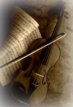 an old violin with sheet music on it