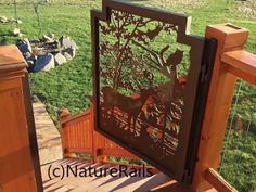 a wooden bench sitting on top of a lush green field next to a forest filled with animals