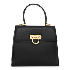 This is an authentic SALVATORE FERRAGAMO Brushed Off Calfskin Iconic Large Top Handle Bag in Black. This chic shoulder bag is finely crafted of black leather. The bag features a rolled top handle, a frontal flap, and a Ferragamo ring clasp closure. This opens to a black fabric interior with a zipper pocket. Classy Women, Handle Bag, Handbag Accessories, Black Fabric, Salvatore Ferragamo, Purse Wallet, Travel Bag, Top Handle, Zipper Pocket