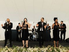 a group of people standing on top of a stage with musical instruments in front of them