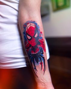 a person with a spiderman tattoo on their arm