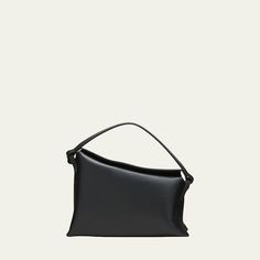 Aesther Ekme "Lune" asymmetrical top handle bag in leather  Top handle  Detachable crossbody strap Can be worn as a top handle or crossbody bag  Fold-over flap top with magnetic closure  Interior, one slip pocket  Lining: Polyester Approx. 7.3"H x 11.6"W x 3.5"D Made in Spain Asymmetrical Tops, Handle Bag, Leather Top, Crossbody Strap, Magnetic Closure, Top Handle, Crossbody Bag, Top Handle Bag, Tops Designs