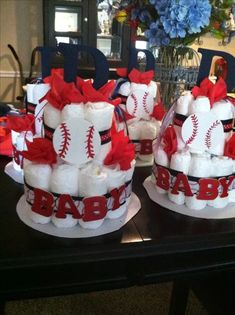 baseball themed diaper cakes are sitting on a table