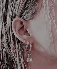 a close up of a person's ear wearing earrings