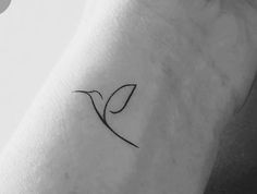 a small bird tattoo on the left arm and shoulder, with a single line in the middle