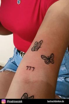 a woman's arm with butterflies on it and the word pi written in black ink