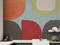 a kitchen with an abstract wallpaper and white counter tops in front of the sink