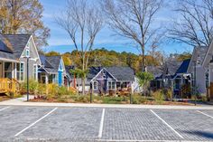 a row of houses with lots of windows and trees in the backgrouds