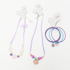 Total Girl 'Ballet Jewels Collection' Set, Lot Of 3 Pieces Colors/ Features: Ribbon Corded Adjustable Necklaces, Purple, Green, Pink, Blue, Iridescent, Silver Tone, Star Charm Accents, Glitter Approximate Size: Necklaces Are 20 Inches Long; 2 1/2" Diameter On Bracelets Retails For $9.99 Each; Total Value Of $29.97 Cheap Purple Bracelets For Beach, Cheap Purple Jewelry With Charms, Adjustable Purple Playful Necklace, Necklaces Purple, Playful Adjustable Purple Necklace, Playful Purple Adjustable Necklace, Hand-strung Purple Beach Jewelry, Total Girl, Adjustable Multi-strand Purple Beaded Necklaces