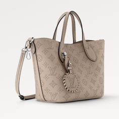 The Mahina Perforated Leather Floral M Handbag combines function and casual sophistication. The interior compartment, with a grab-and-release zip pocket, has room for everyday essentials. There are two handles or elbows for carrying, as well as an adjustable and removable strap for shoulder and cross body wear. Luxury Everyday Bag With Adjustable Handle, Luxury Bags With Double Adjustable Handle, Luxury Bags With Adjustable Handle, Designer Tote Bag With Adjustable Handle, Designer Handheld Bag With Adjustable Handle, Elegant Satchel With Adjustable Handle For Errands, Luxury Satchel With Adjustable Handle For Shopping, Luxury Shopping Satchel With Adjustable Handle, Luxury Beige Bags With Adjustable Handle