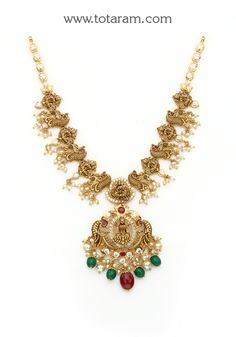 22 Karat Gold "Lakshmi - Peacock" Necklace With Cz, Color Stones, Pearls & Beads (Temple Jewellery)

 Experience Divine Beauty with our 22 Karat Gold "Lakshmi - Peacock" Necklace! Indulge in the exquisite craftsmanship of Indian jewelry with our stunning 22 Karat Gold "Lakshmi - Peacock" Necklace. Adorned with sparkling CZ, colorful stones, lustrous pearls, and delicate beads, this piece exudes timeless elegance and charm. The intricate design featuring a divine Lakshmi motif and a majestic peac Peacock Necklace, Colorful Stones, Divine Beauty, Color Stones, Gold Necklace Designs, Temple Jewellery, Intricate Design, Gold Pearl, 22k Gold