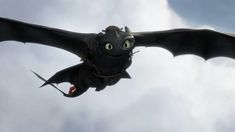 a black dragon flying through the sky with its wings spread out and eyes wide open