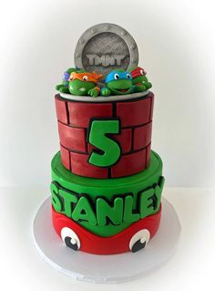 a three tiered cake decorated with teenage mutant characters