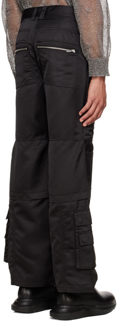 Polyester satin cargo pants. · Hinged O-ring at interior waistband · Belt loops · Four-pocket styling · Zip-fly · Zip, flap, and cargo pockets · Pen slots at legs · Silver-tone hardware Supplier color: Techno black Satin Cargo Pants, Polyester Satin, O Ring, Luxury Streetwear, Cargo Shorts, Cargo Pants, Designer Fashion, Slots, Mens Short