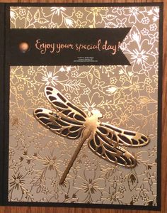 a card with a dragonfly on it and the words enjoy your special day written in gold