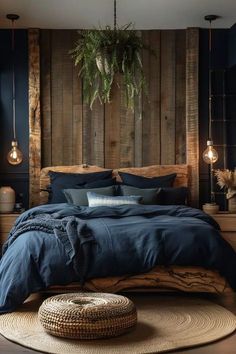 a bed with blue linens and pillows in a room that has wood paneling on the walls