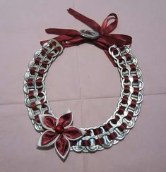 a red and silver bracelet with flowers on it