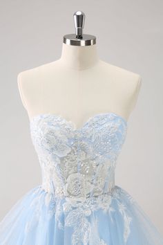 a light blue and white dress on a mannequin headdress with flowers