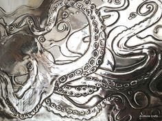 an octopus is depicted in this metal plate