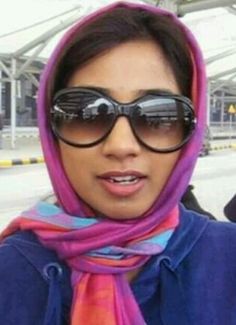 a woman wearing sunglasses and a colorful scarf