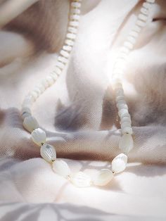 This white mother of pearl pikake shell necklace evokes visions of Hawaii's flower leis and reflect Hawaii's natural abundance. This unique beauty is ready for you and your tropical escape. ✦ DETAILS ✦✧ Name: Mau loa (maow LOah) - always and forever.✧ White Mother of Pearl beads.✧ 14kt Gold Filled clasp and beads.✧ All Ke Aloha Jewelry pieces come packaged thoughtfully, beautifully, and ready for gift giving. Mother Of Pearl Shell-shaped Necklace In Pearl White, Pearl White Mother Of Pearl Shell-shaped Necklace, White Spiritual Shell Necklace As A Gift, White Spiritual Shell Necklace, Spiritual White Shell Necklace Gift, Spiritual White Shell Necklace, Spiritual White Mother Of Pearl Jewelry, White Adjustable Shell Necklace Spiritual Style, Delicate White Mother Of Pearl Jewelry