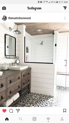 a bathroom with white walls and black and white floor tiles on the floor, along with two sinks