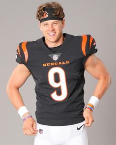 a man in a football uniform is posing for a photo with his hands on his hips