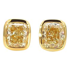 RareGemWorld's classic GIA certified diamond earrings. Mounted in a beautiful 18K Yellow Gold setting with natural cushion cut yellow diamonds. These earrings are guaranteed to impress and enhance your personal collection! Total Weight: 1.46cts Natural Fancy Light Yellow Cushion Cut Diamond Measurements: 5.63 x 4.84 x 3.13 mm Carat Weight: 0.73cts Clarity Grade: VS2 Natural Fancy Light Yellow Cushion Cut Diamond Measurements: 5.35 x 4.54 x 3.33 mm Carat Weight: 0.73cts Clarity Grade: VVS2 18K Yellow Gold All diamonds are guaranteed natural International Shipments: Please note that customers are responsible for all import duties and taxes applicable to the country of shipment Returns: Returns accepted in original format within 14 days of receipt Do not forget to view our entire inventory! T Yellow Diamond Earrings, Classic Diamond Earrings, Earring Video, Yellow Diamond Earring, Yellow Cushion, Fancy Light, Yellow Cushions, Yellow Diamonds, Natural Cushions