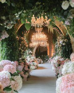 an archway decorated with flowers and chandelier